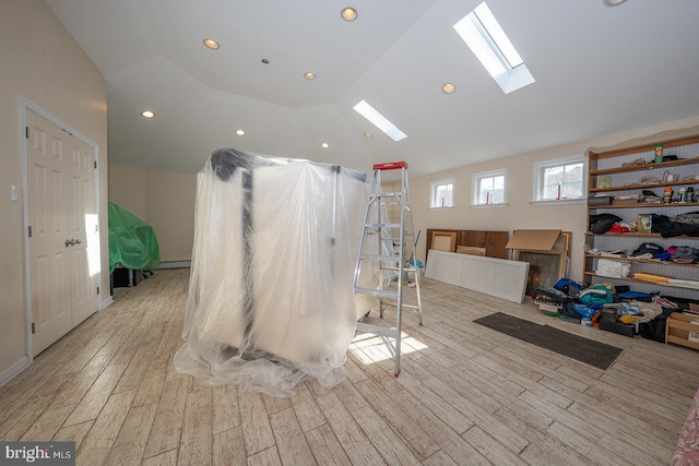 interior space with hardwood / wood-style flooring, baseboard heating, and lofted ceiling