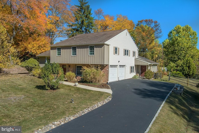 view of front of home featuring a garage and a front lawn