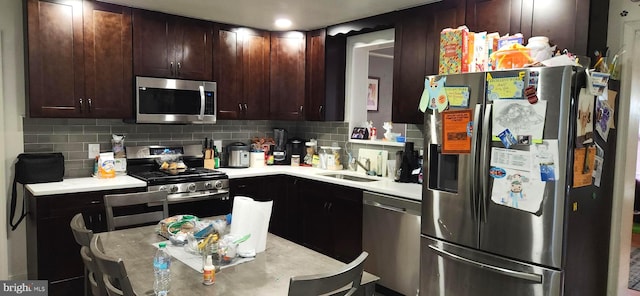 kitchen featuring stainless steel appliances, tasteful backsplash, and sink