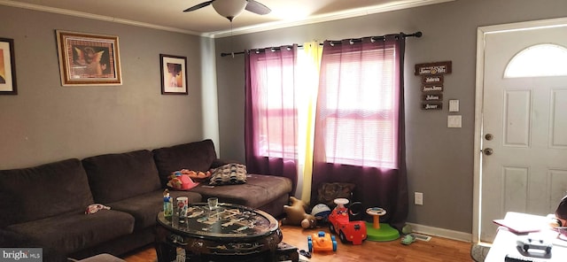 living room featuring ornamental molding, hardwood / wood-style floors, ceiling fan, and plenty of natural light