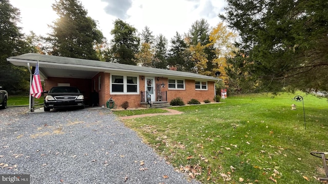 ranch-style home featuring a front lawn and a carport