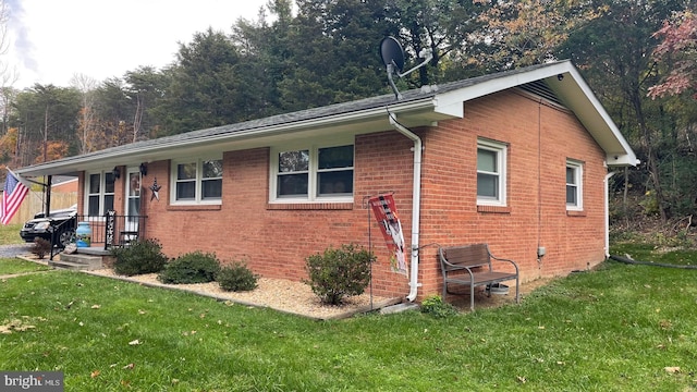 view of home's exterior featuring a yard and covered porch