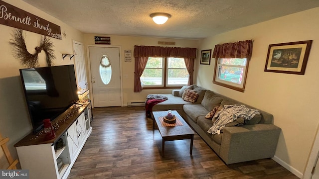 living room featuring baseboard heating, a textured ceiling, and dark hardwood / wood-style floors