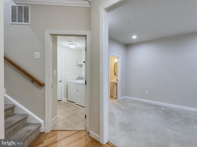 hall featuring light hardwood / wood-style flooring and washer and clothes dryer