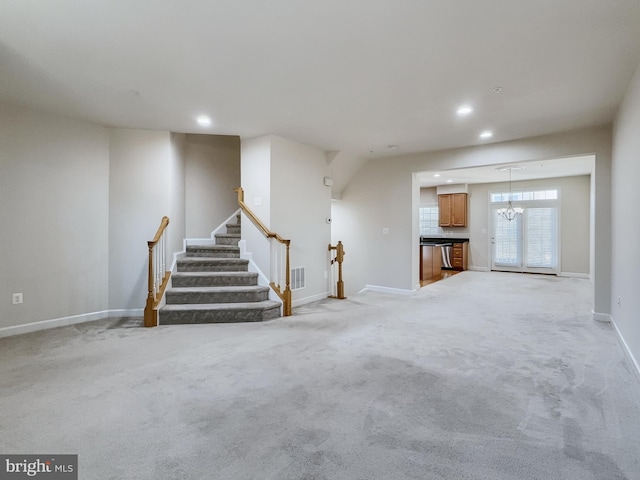 unfurnished living room with light colored carpet