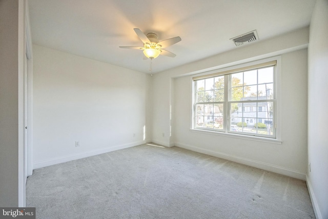 carpeted spare room with ceiling fan