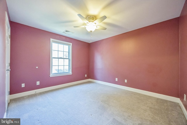 carpeted spare room with ceiling fan