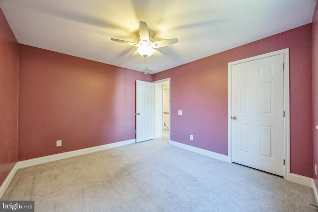 unfurnished bedroom featuring light carpet and ceiling fan