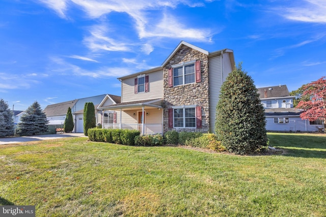 front of property featuring a porch, a front lawn, and a garage