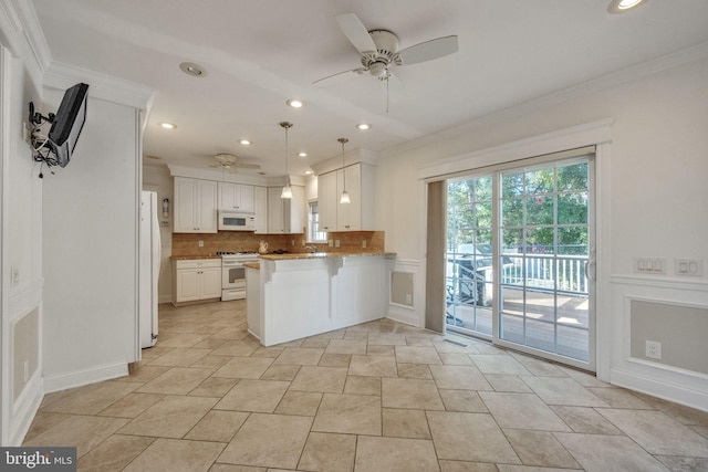 kitchen with kitchen peninsula, white cabinets, ceiling fan, backsplash, and white appliances