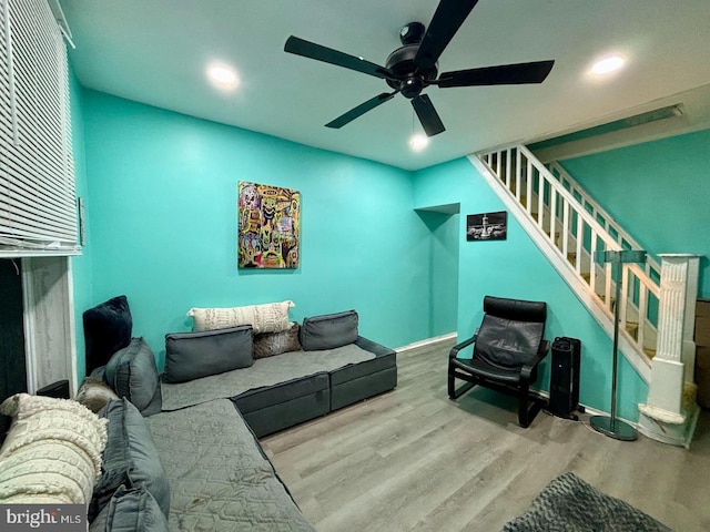 living room featuring ceiling fan and light wood-type flooring