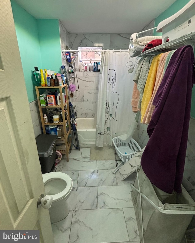 bathroom featuring shower / bath combo with shower curtain and toilet