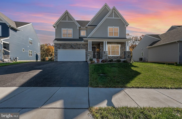 craftsman-style home with a yard, cooling unit, and a garage