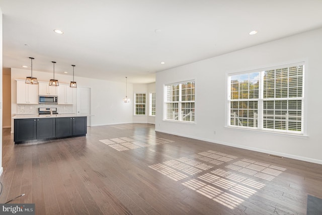 unfurnished living room featuring dark hardwood / wood-style flooring