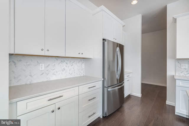 kitchen featuring white cabinetry, stainless steel fridge, tasteful backsplash, and dark hardwood / wood-style floors