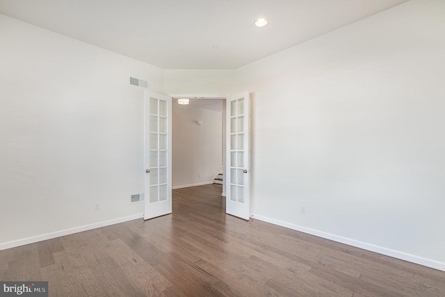 empty room with french doors and wood-type flooring