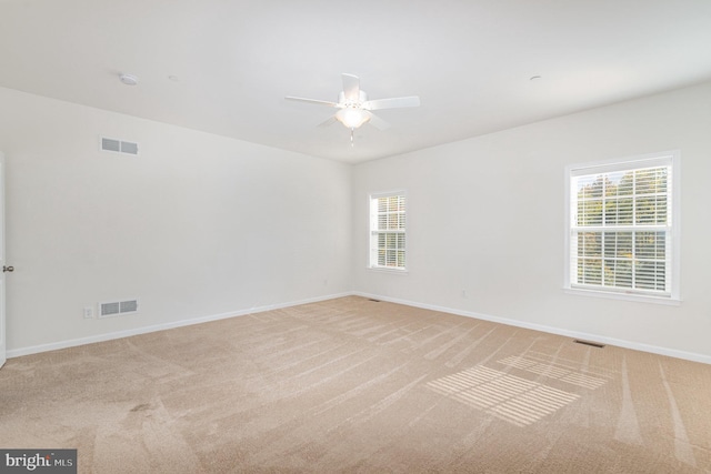 empty room featuring light carpet and ceiling fan