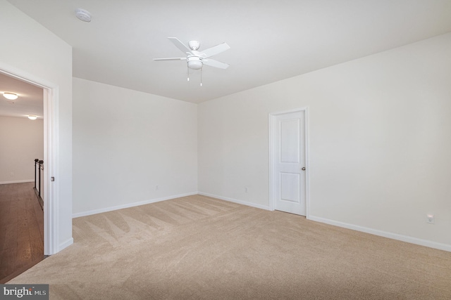 empty room featuring carpet flooring and ceiling fan