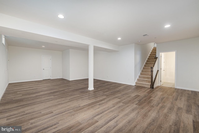 basement with dark hardwood / wood-style flooring