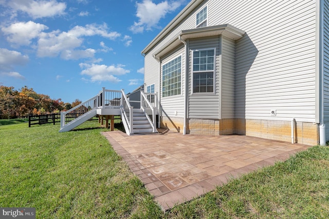 exterior space featuring a patio area and a lawn