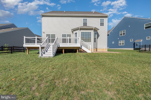 rear view of house with a yard and a deck