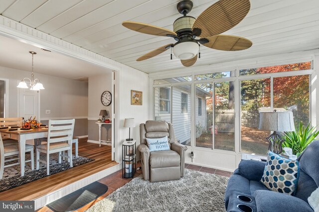 interior space with wood ceiling and ceiling fan with notable chandelier