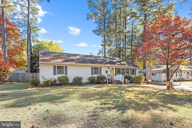 ranch-style house featuring a carport and a front yard