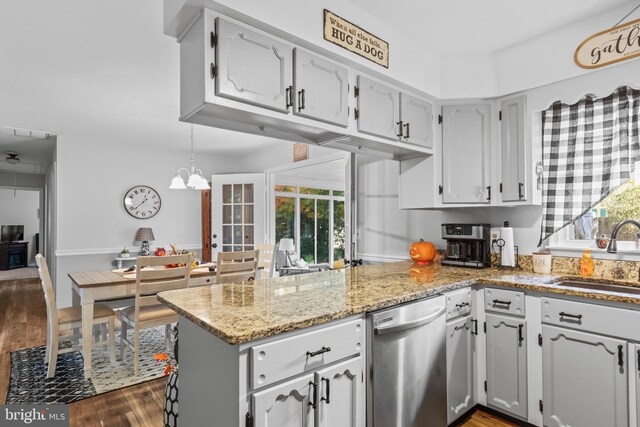 kitchen with dishwasher, sink, plenty of natural light, and dark hardwood / wood-style flooring