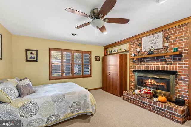 bedroom with ceiling fan, a fireplace, and light colored carpet