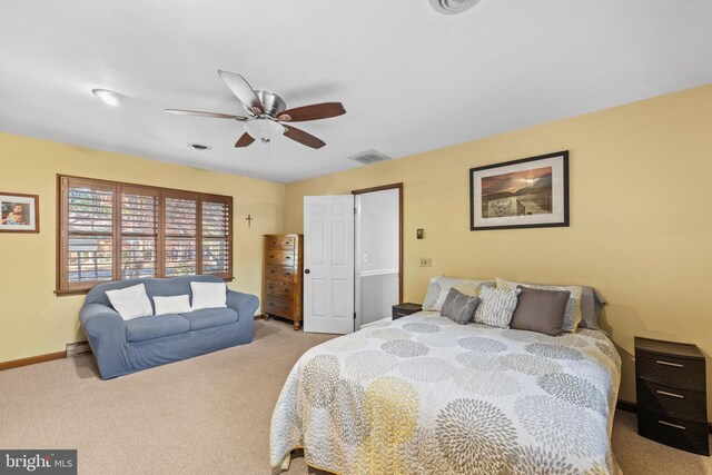 carpeted bedroom featuring a baseboard heating unit and ceiling fan