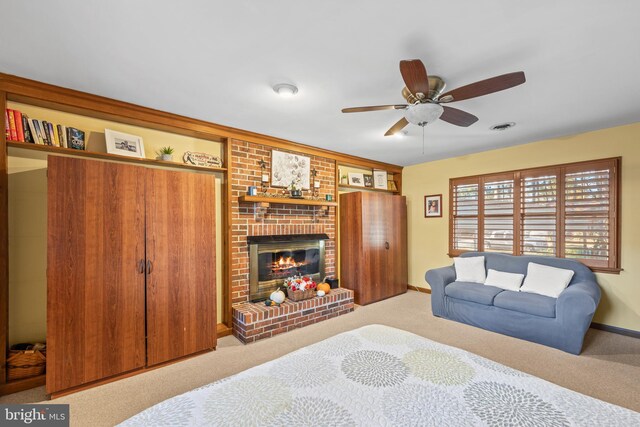 carpeted bedroom featuring a closet, ceiling fan, and a brick fireplace