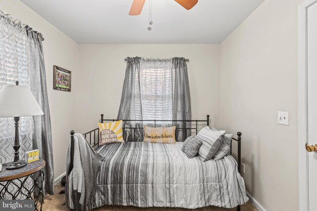 bedroom featuring ceiling fan and carpet