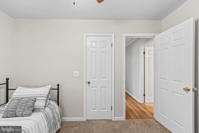 bedroom with light colored carpet and ceiling fan