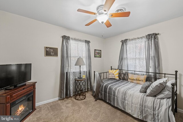 bedroom with light carpet and ceiling fan