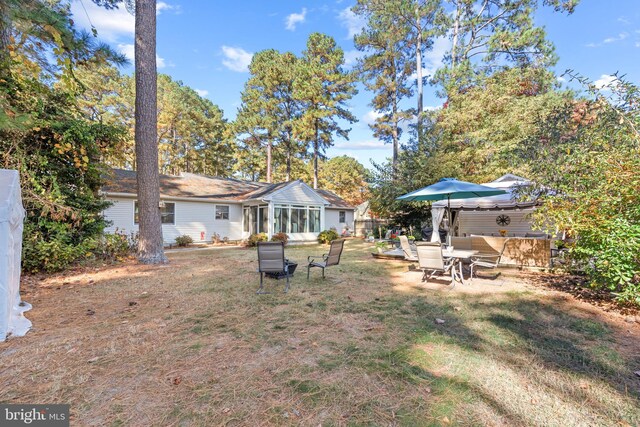 view of yard featuring a patio and a sunroom