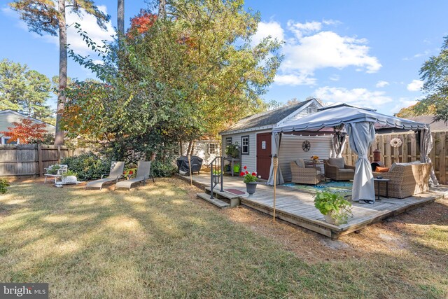 view of yard with a gazebo, a wooden deck, and an outdoor hangout area