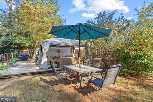 view of patio featuring a wooden deck and grilling area