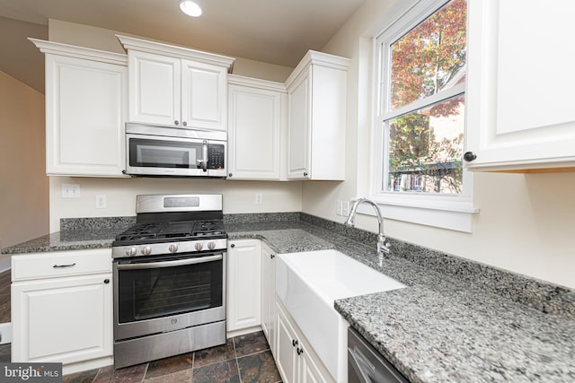 kitchen with sink, appliances with stainless steel finishes, and white cabinets