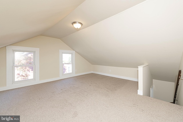 bonus room featuring lofted ceiling and carpet floors