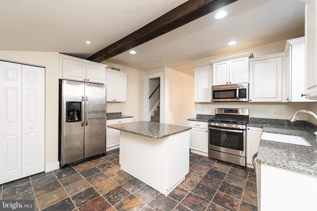 kitchen featuring a center island, white cabinets, stainless steel appliances, and sink