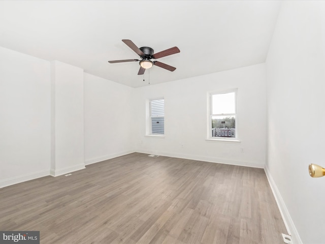 spare room with light hardwood / wood-style flooring and ceiling fan