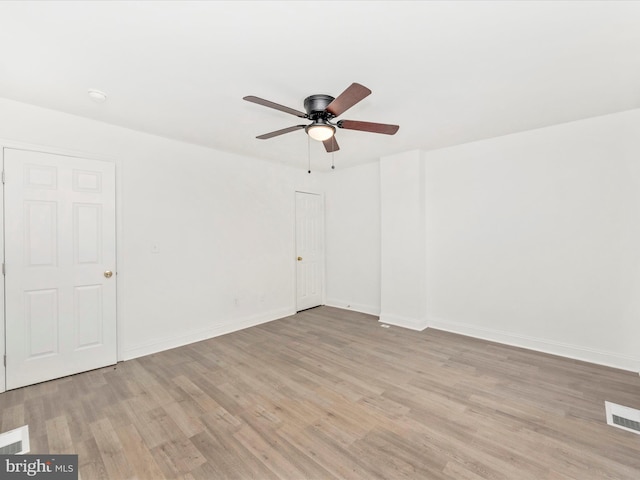 empty room with light hardwood / wood-style flooring and ceiling fan