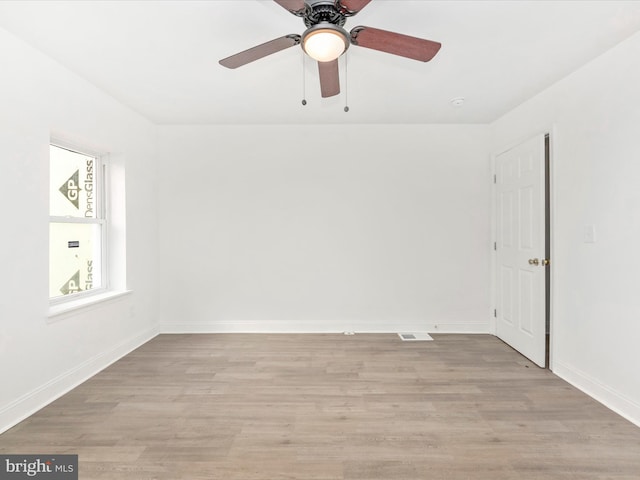 spare room featuring light wood-type flooring and ceiling fan