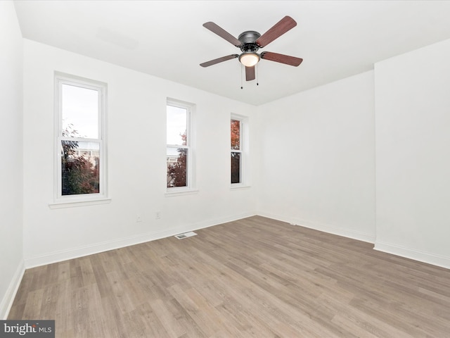 spare room with light wood-type flooring and ceiling fan