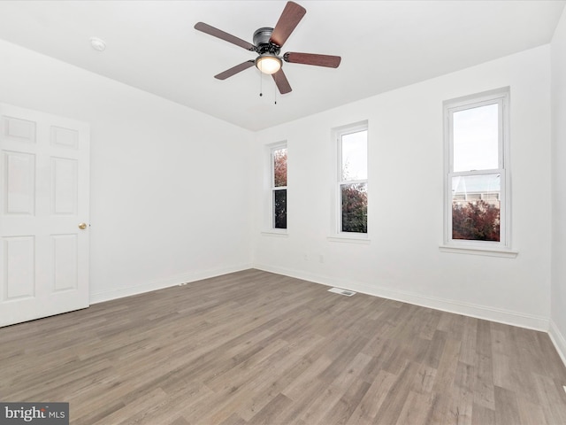 empty room featuring light hardwood / wood-style flooring and ceiling fan