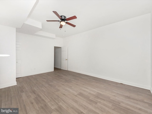 spare room with light hardwood / wood-style floors and ceiling fan