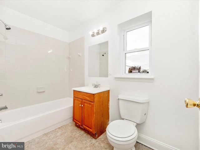 full bathroom with vanity, tiled shower / bath, and toilet