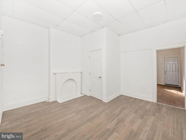 interior space featuring a paneled ceiling and light wood-type flooring