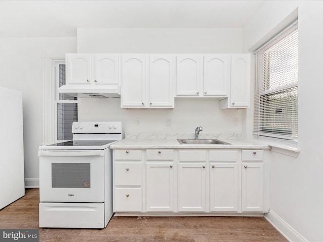 kitchen featuring white appliances, sink, light wood-type flooring, and white cabinets