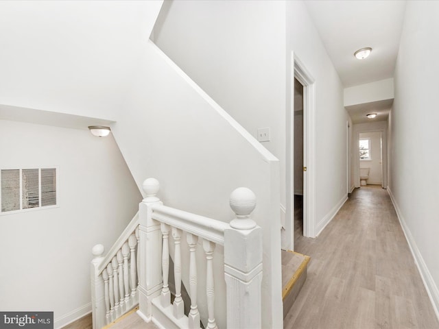 stairway with hardwood / wood-style flooring